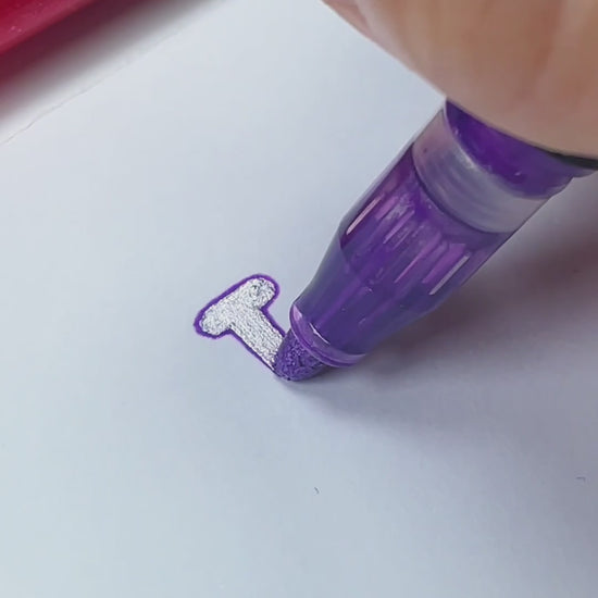 Writing a Christmas card with magic outline markers