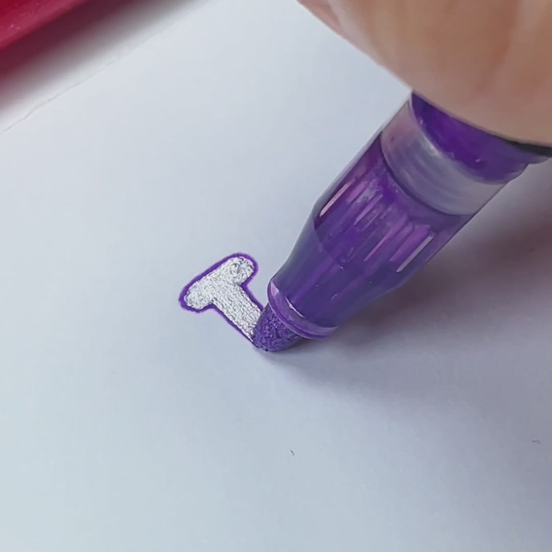 Writing a Christmas card with magic outline markers